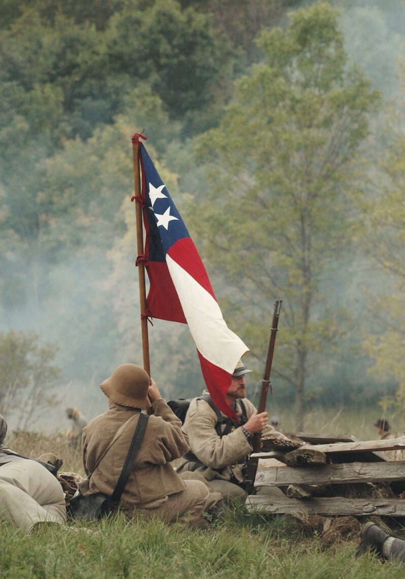 Photo by Jen Theodore soldiers waving flag in battlefield